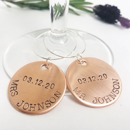 Copper wine glass charms stamped with a couple's names and wedding date